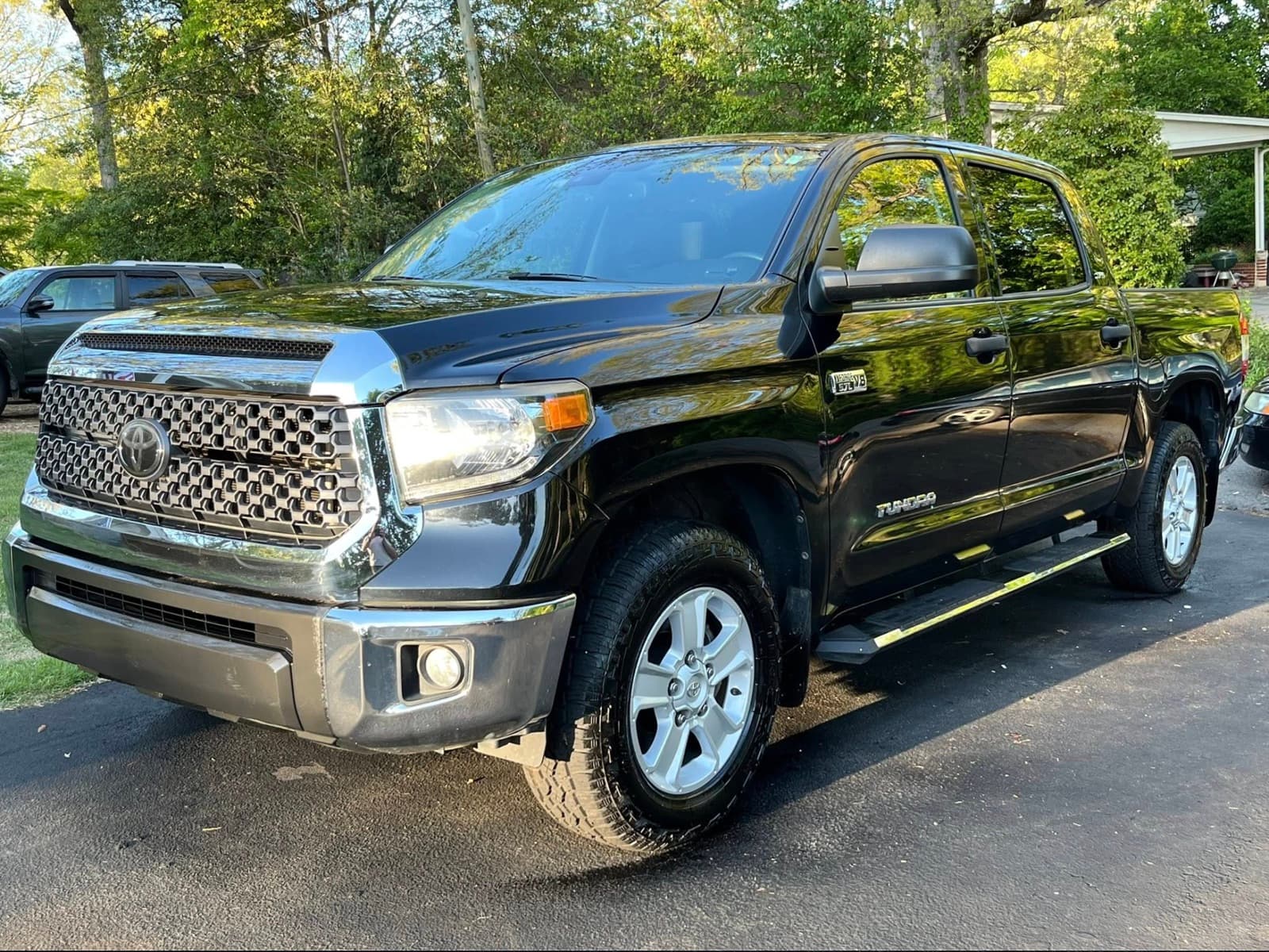Black pickup truck cleaned and shining in a residential driveway